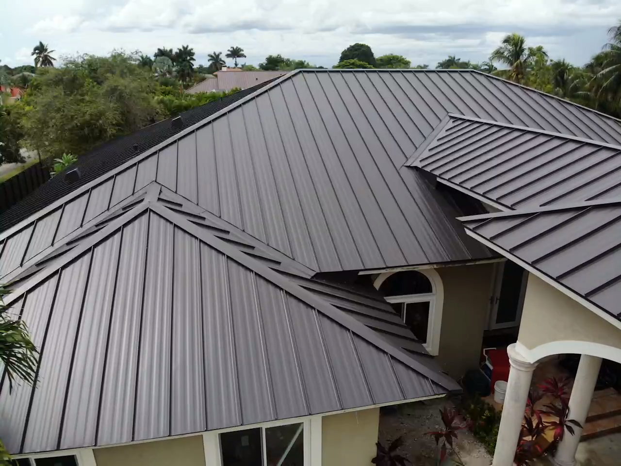 An aerial view of a house with a metal roof.