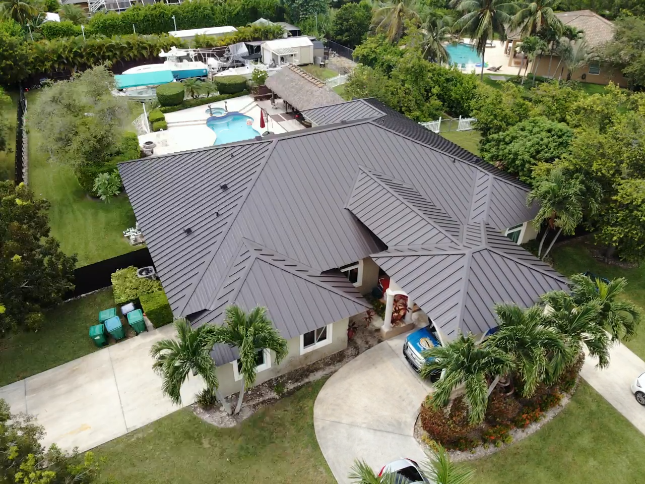 An aerial view of a house with a black roof.