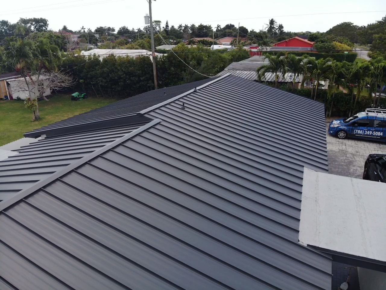 An aerial view of a house with a metal roof.