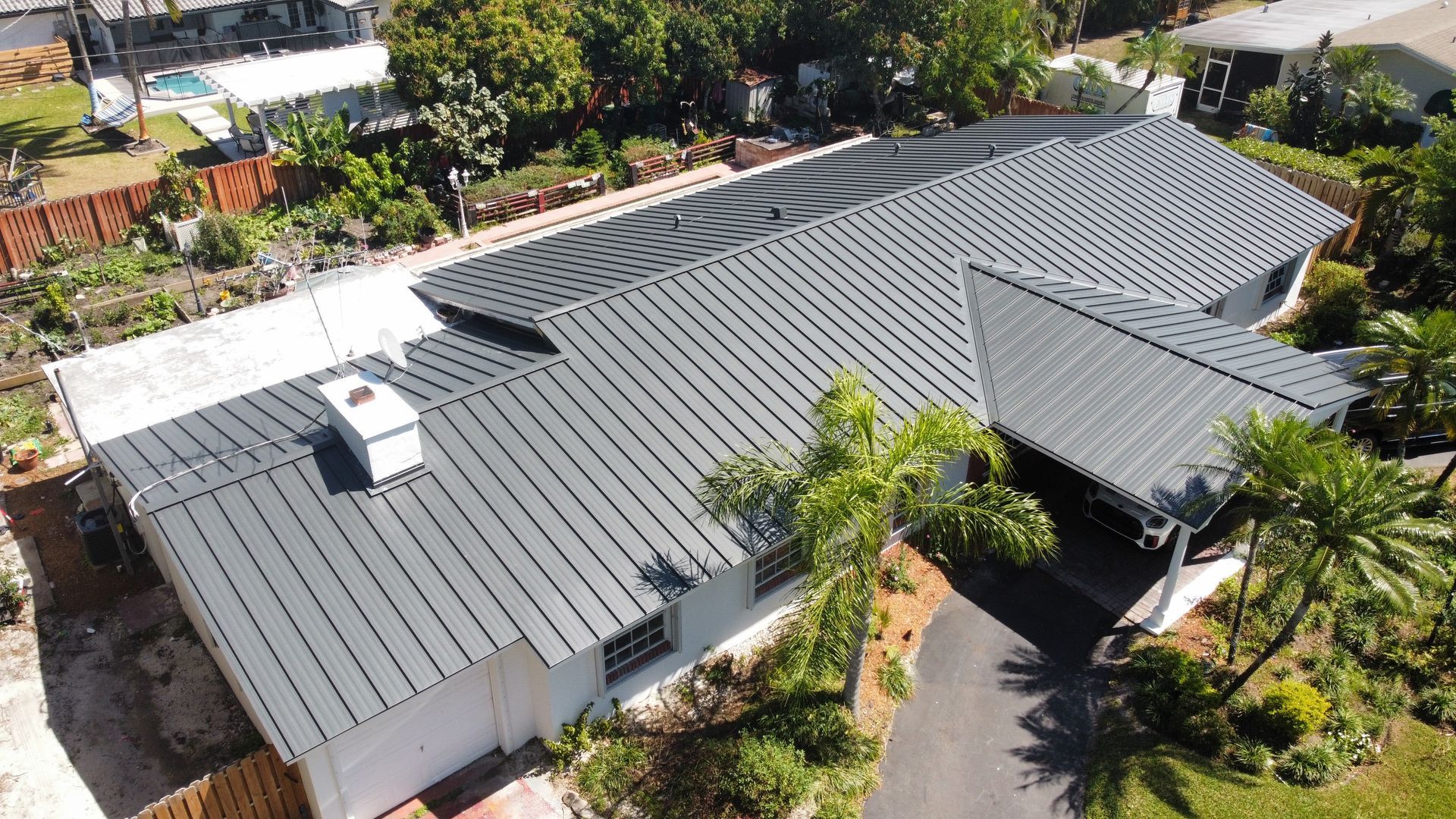 An aerial view of a house with a gray roof.