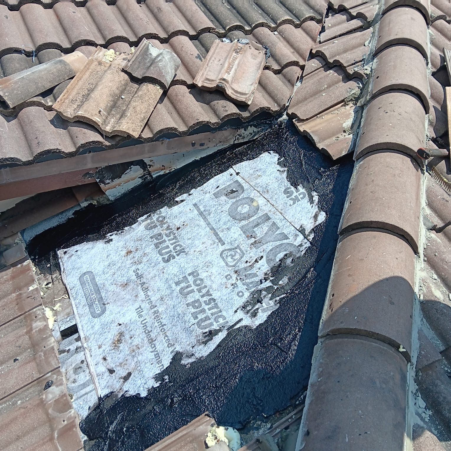 A roof with a hole in it and a piece of paper on it.