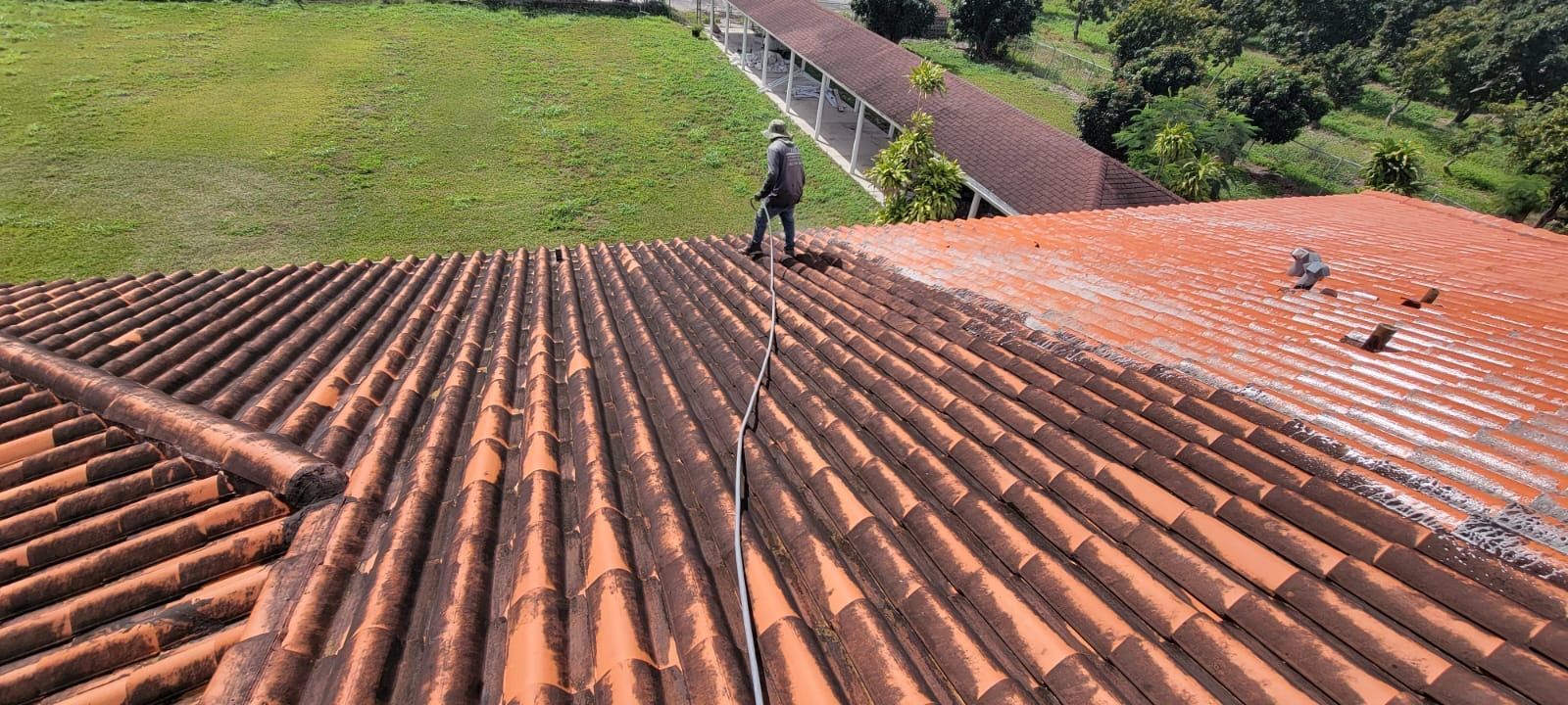 A man is standing on the roof of a building.