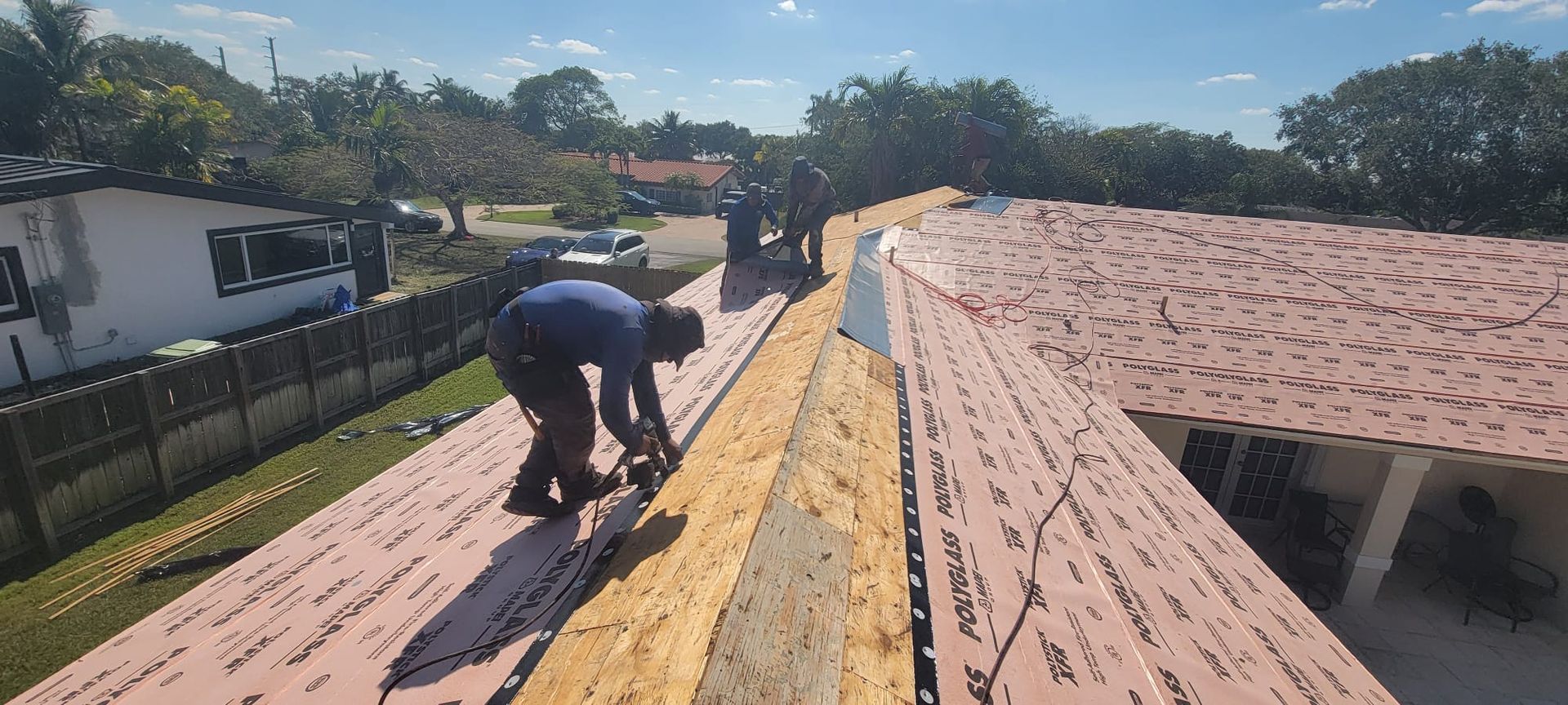 A man is working on the roof of a house.