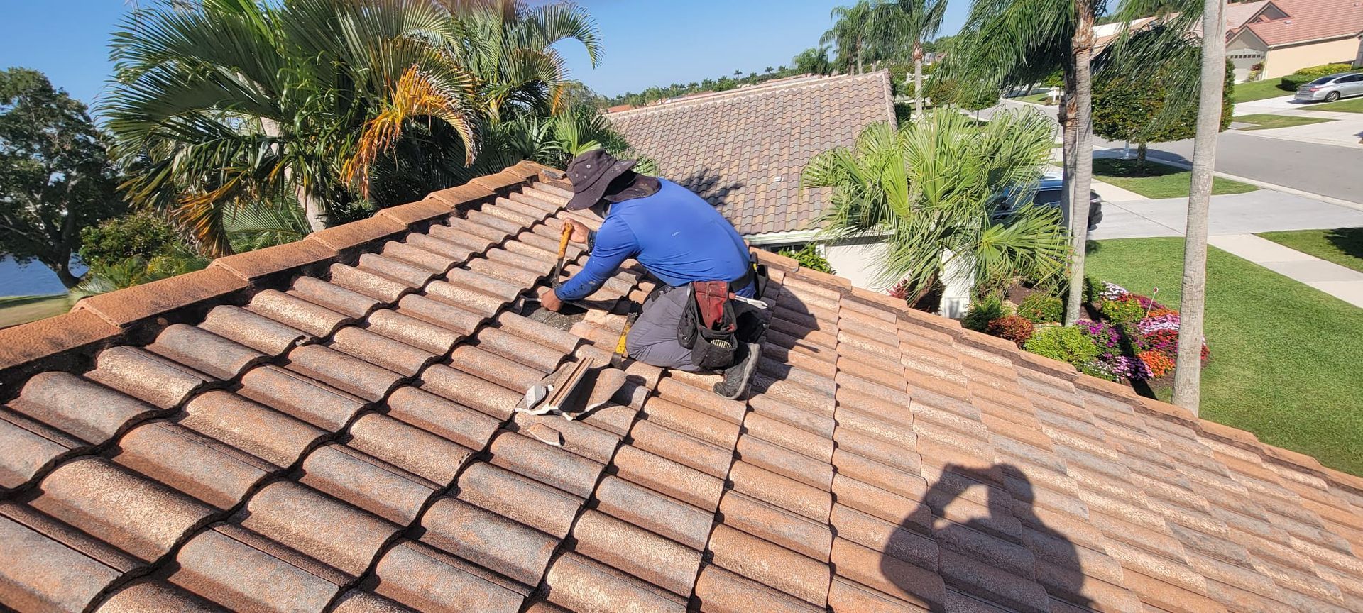A man is working on the roof of a house.