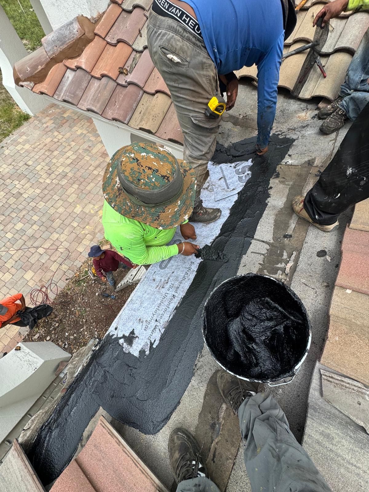 A group of people are working on a roof.