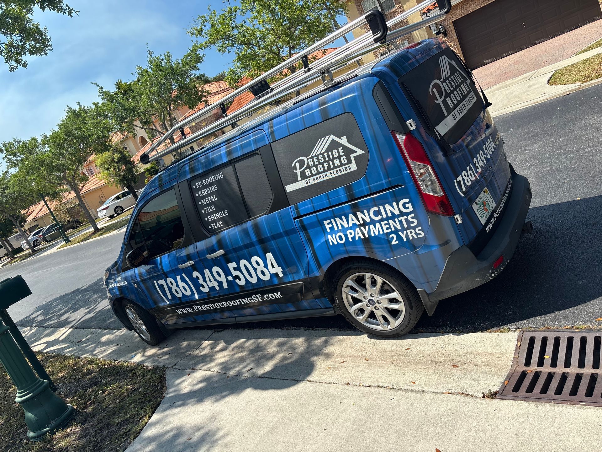 A blue van is parked on the side of the road.