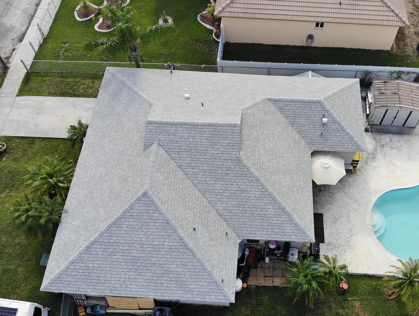 An aerial view of a house with a pool in the backyard.