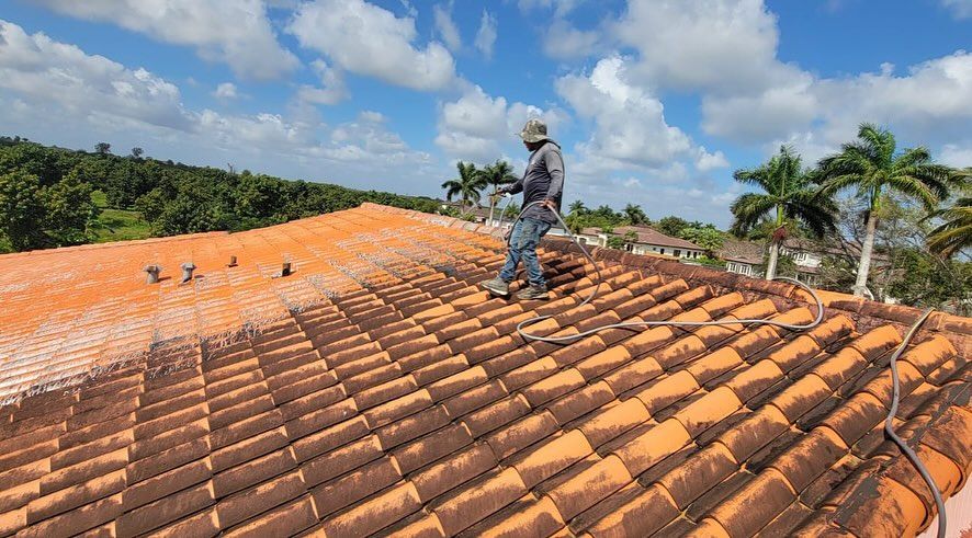 A man is standing on top of a tiled roof.
