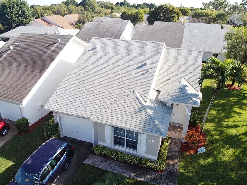 An aerial view of a house with a car parked in front of it.