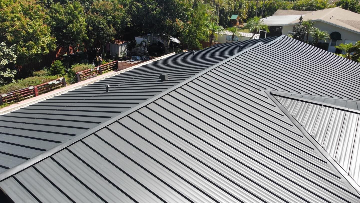 The roof of a house with a black metal roof