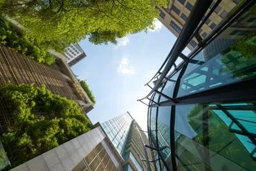 Looking up at a building with trees in front of it