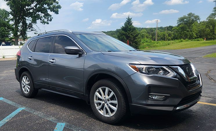 Gray Nissan Rogue SUV parked outside on a sunny day.
