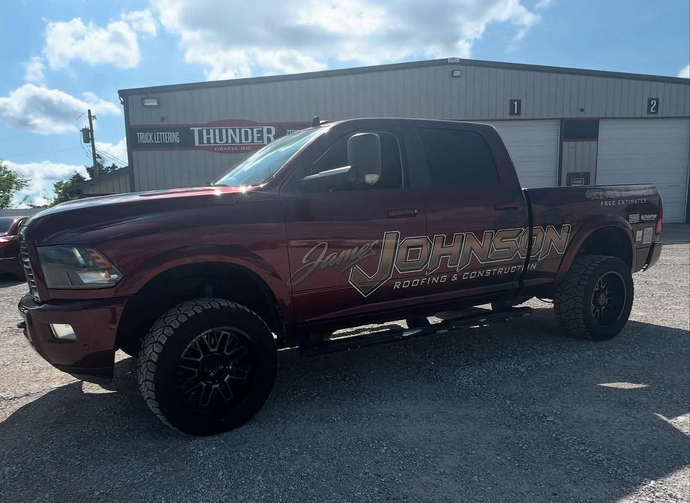 A red pickup truck was parked in front of a building on a sunny day.