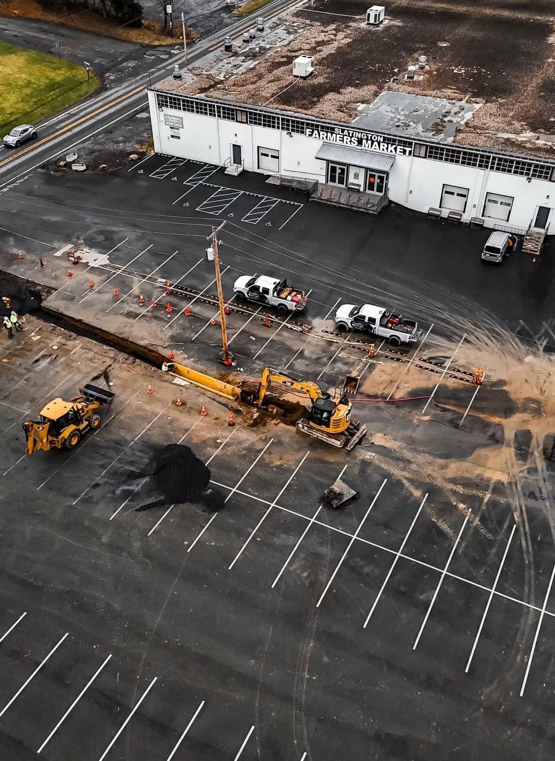 An aerial view of a construction site in a parking lot.