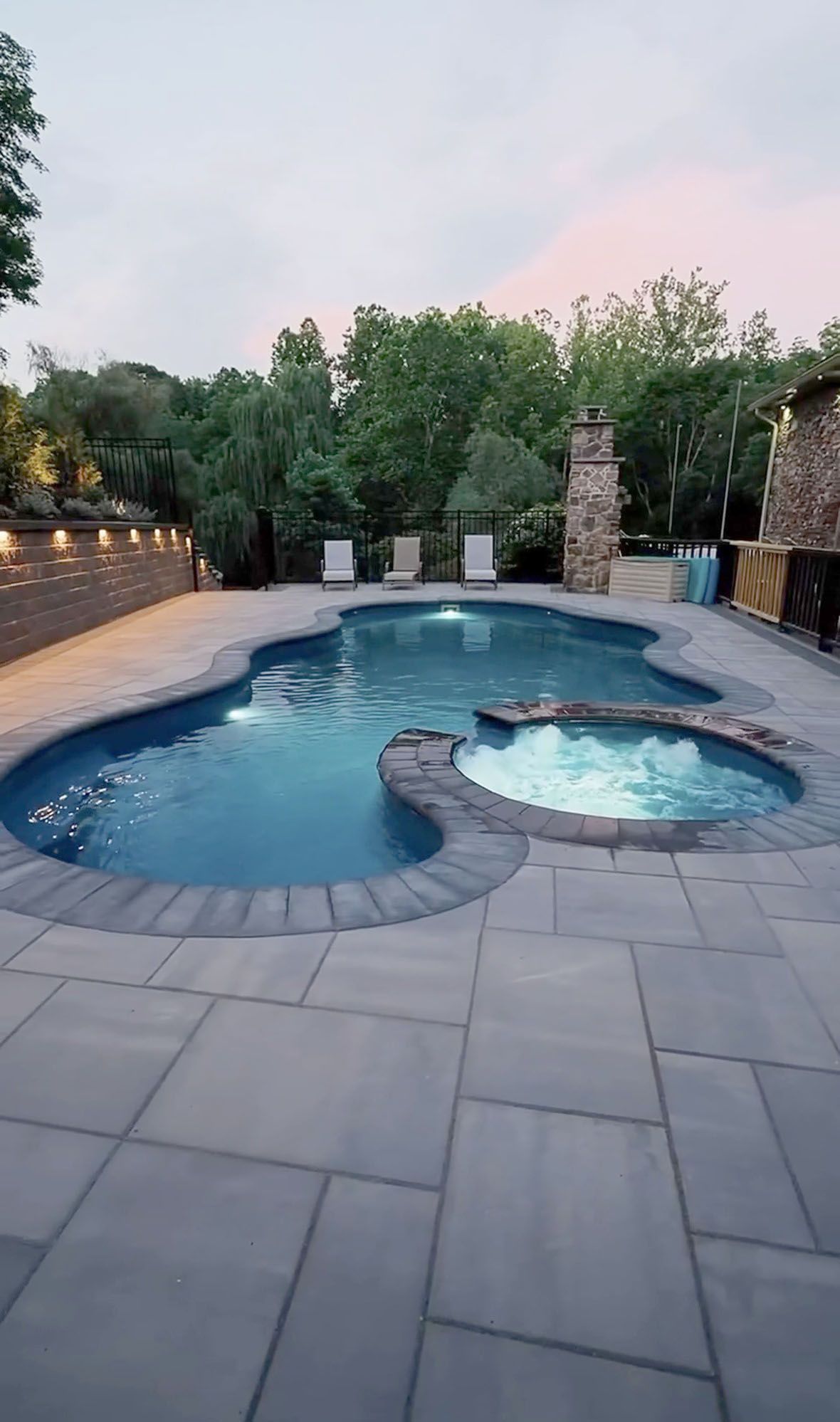 Backyard pool with a built-in hot tub