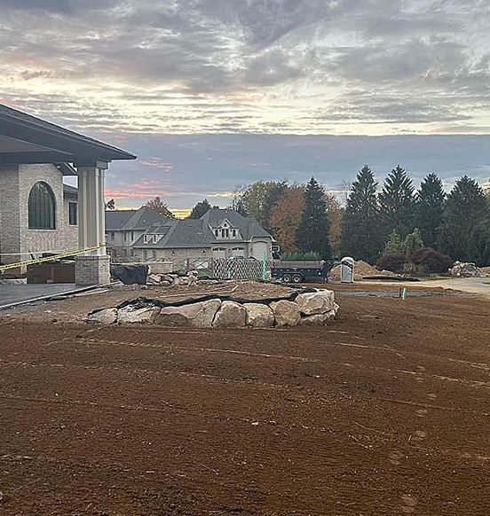 a house is being built in the middle of a dirt field .