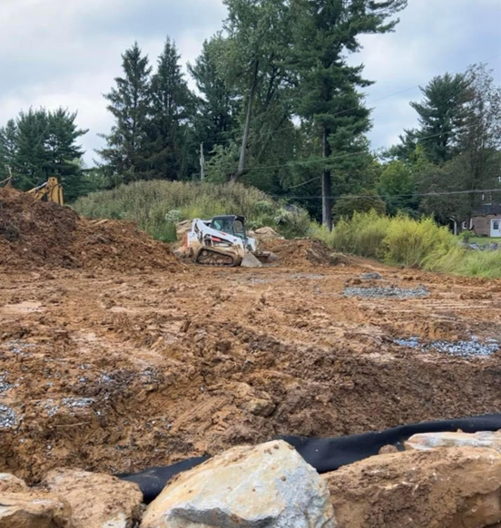 a bulldozer is driving through a pile of dirt and rocks