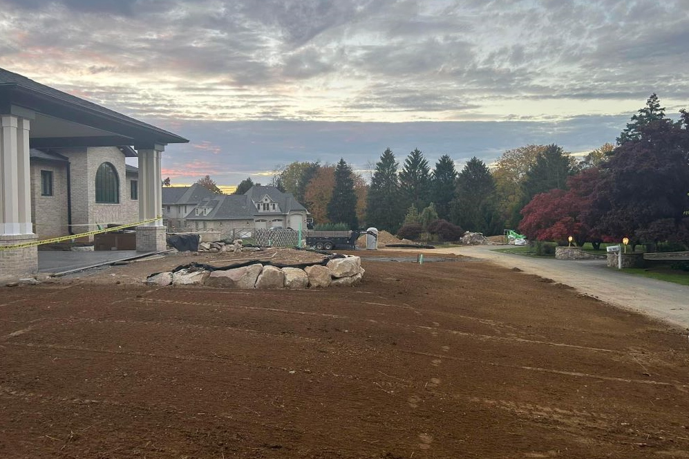 a large house is being built in the middle of a dirt field