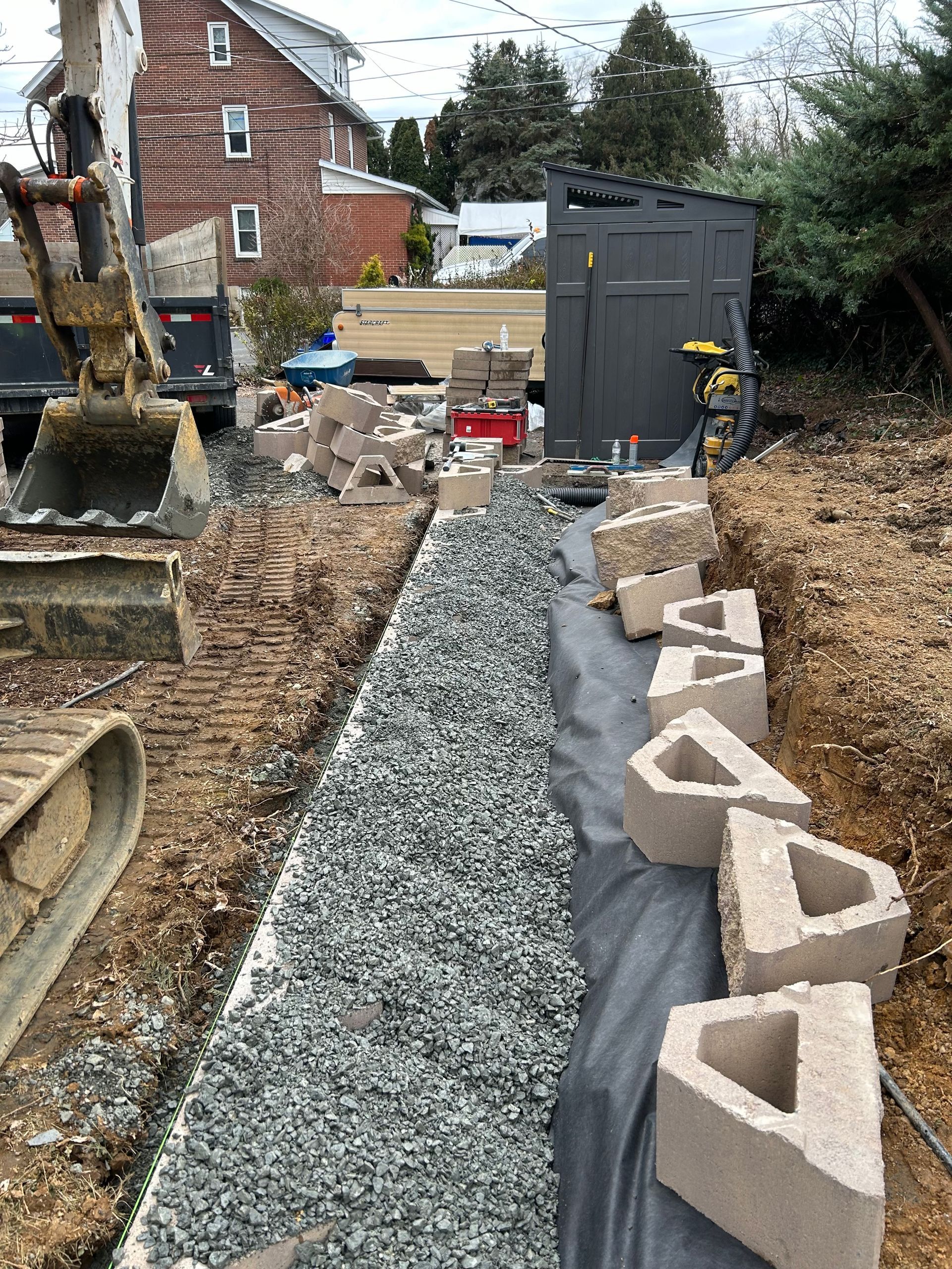 a row of concrete blocks are sitting on top of a pile of gravel .