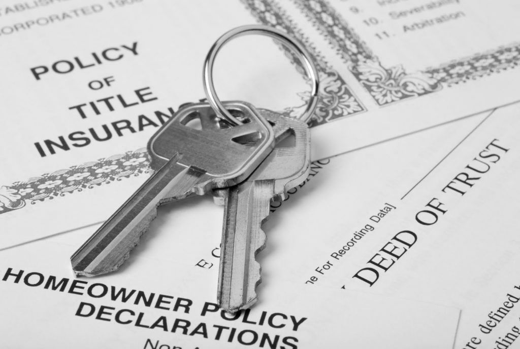 A pair of keys on top of a Homeowner Policy Declaration