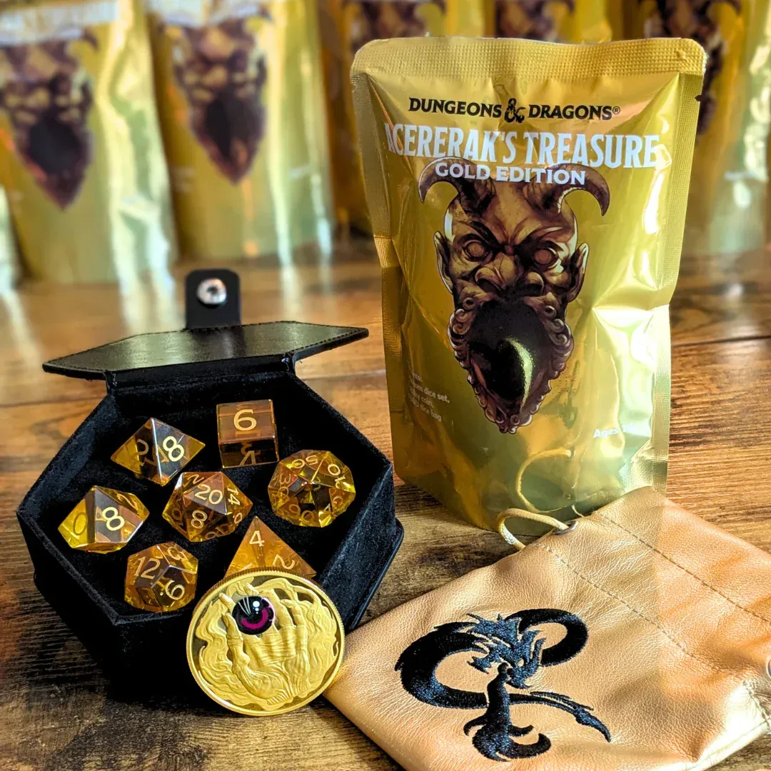 Dungeons & Dragons golden dice set with pouch, display box, and treasure bag on a table