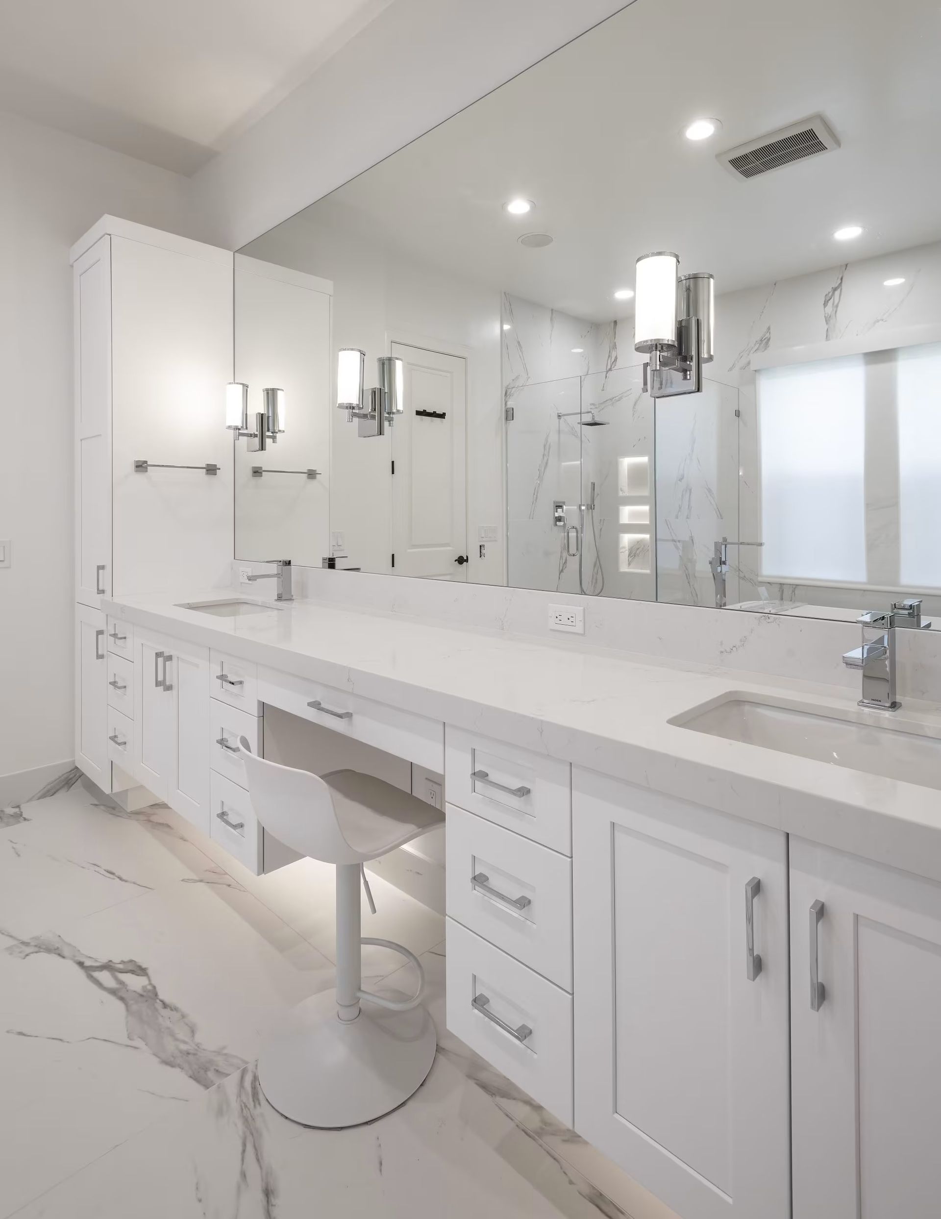 Bright white modern bathroom vanity with large mirror and double sinks