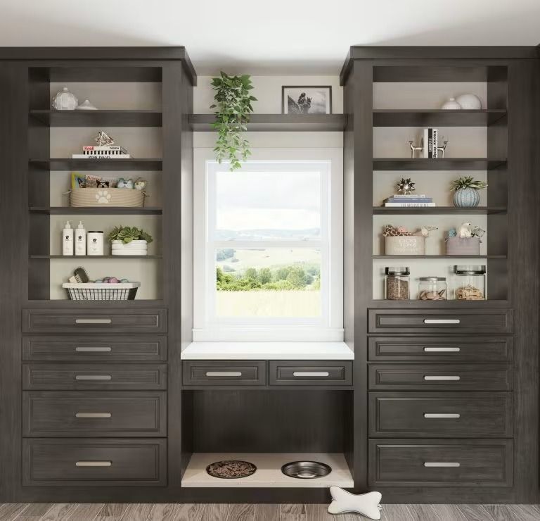 Built-in dark wood storage cabinets flanking a window seat with shelves and decor