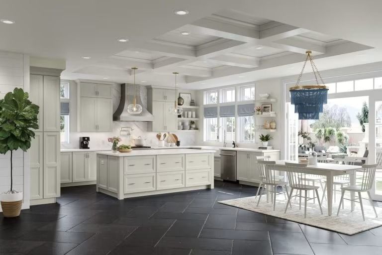 Bright white kitchen and dining room with island, black tiled floor, and a large windowed eating area