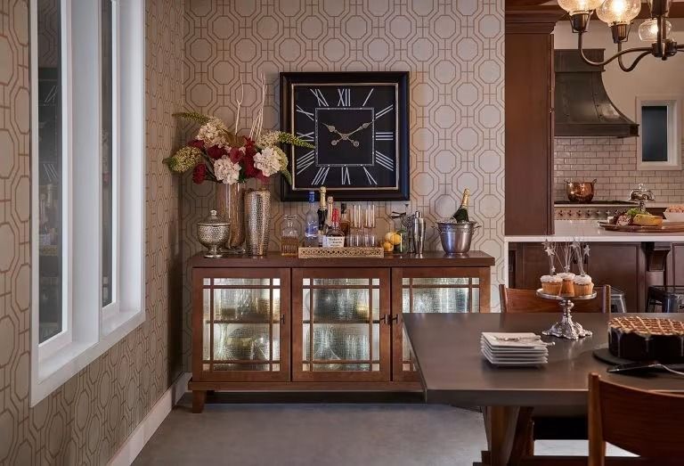 Elegant dining room with glass-front sideboard, wall clock, flowers, and a set table by a window