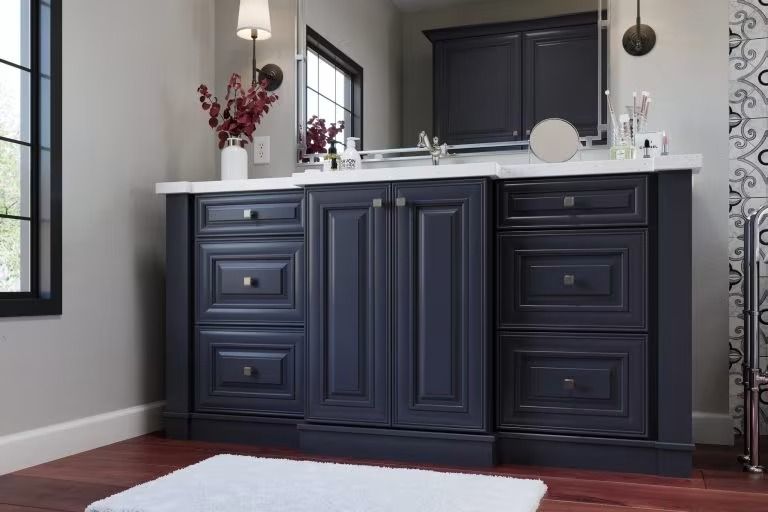 Dark navy bathroom vanity with white countertop, mirror, and red floral accents.