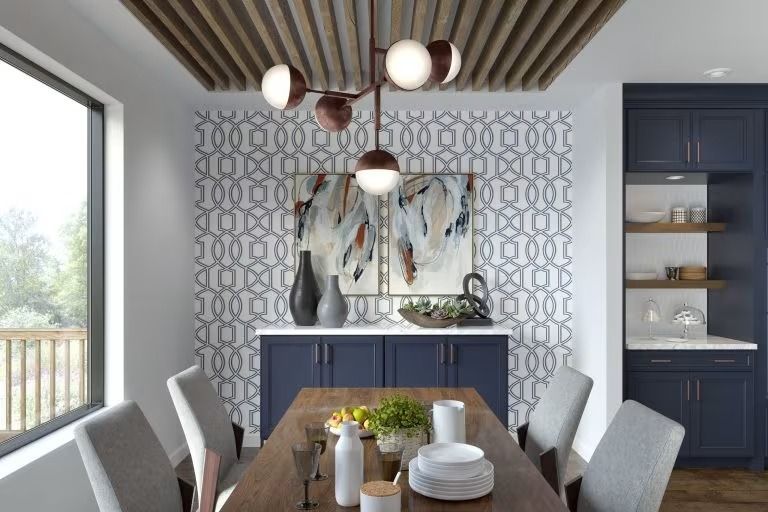 Modern dining room with navy cabinets, patterned wallpaper, abstract art, and a set table