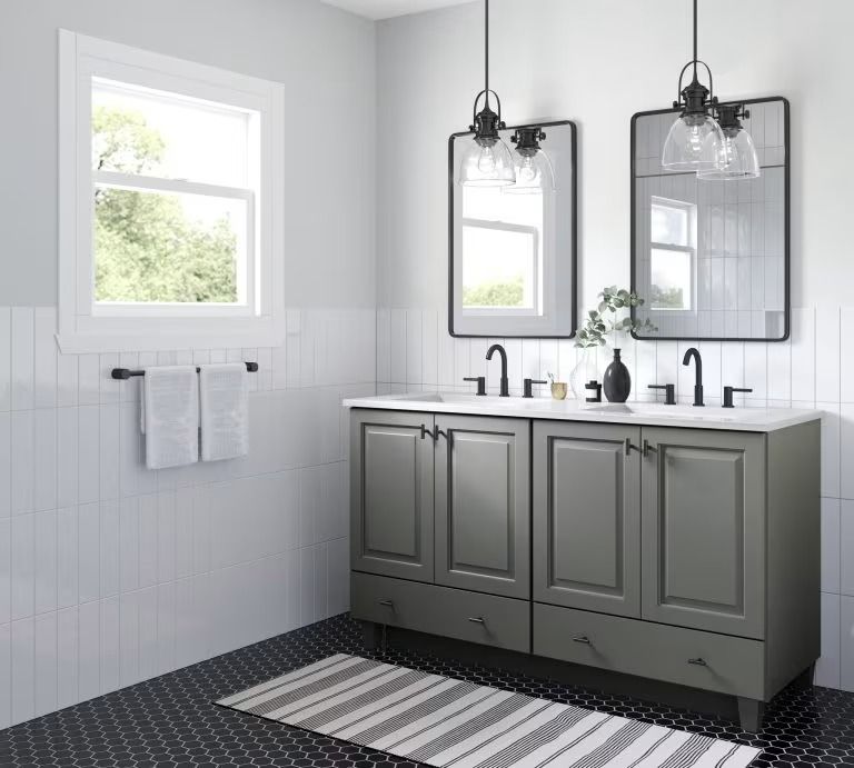 Modern gray bathroom with double vanity, black mirrors, pendant lights, and striped rug