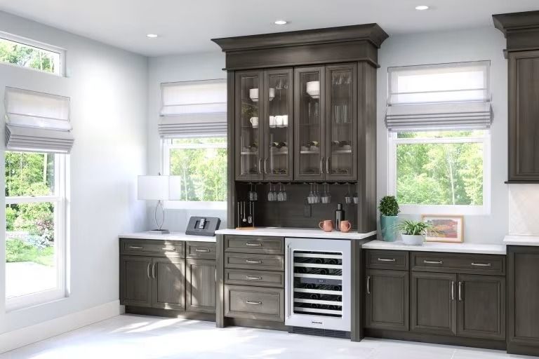 Modern kitchen with dark wood cabinets, white countertops, and large windows with blinds