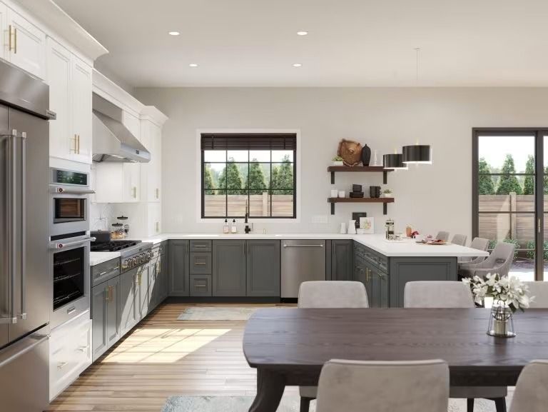 Modern white kitchen with gray cabinets, wood table, and large windows