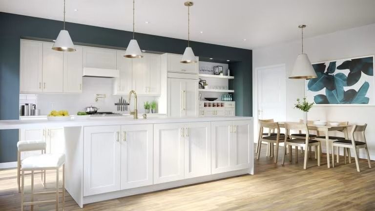 Bright modern kitchen and dining area with white cabinets, pendant lights, wood floors, and teal wall art