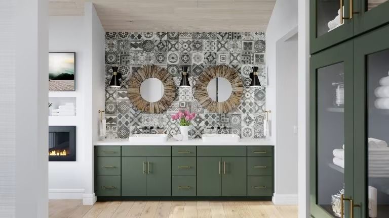 Modern bathroom vanity with sage cabinets, patterned tile backsplash, round mirror, and flowers