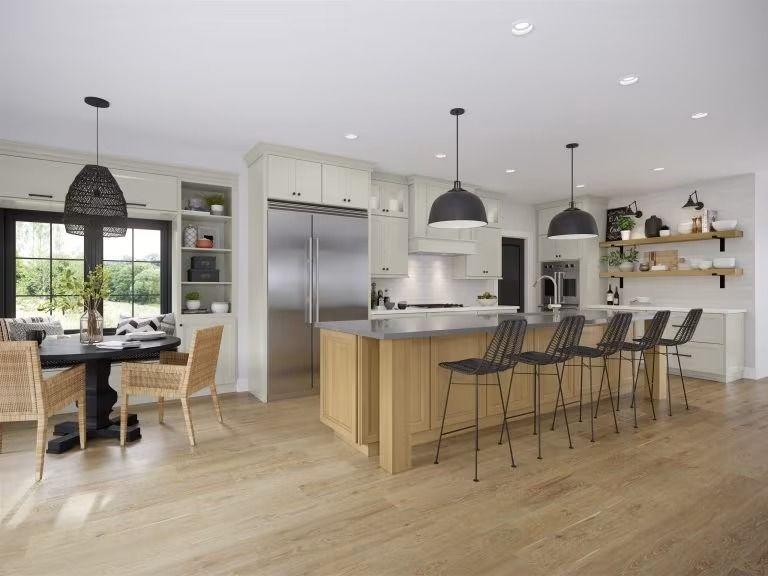 Modern open-plan kitchen and dining area with wood floors, island stools, pendant lights, and stainless steel fridge