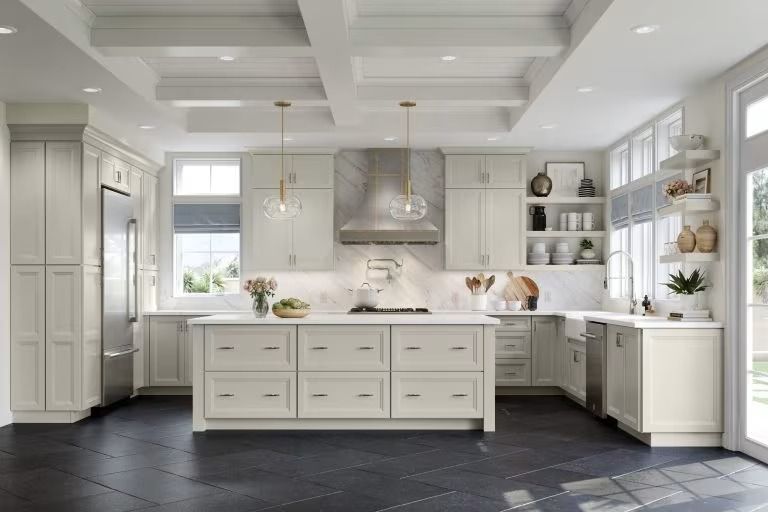 Bright white kitchen with island, stainless range hood, and dark tiled floor