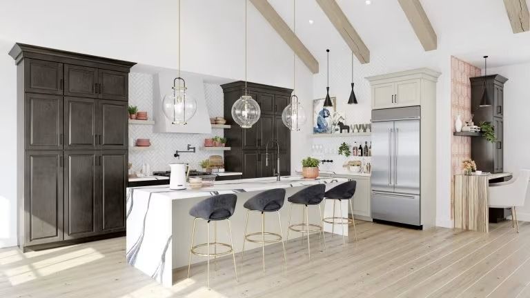 Bright modern kitchen with white island, black stools, hanging lights, and stainless steel fridge