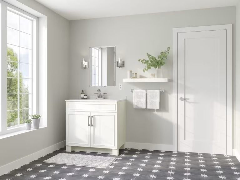 Minimal white bathroom with vanity, mirror, shelf, door, and gray checkered floor.