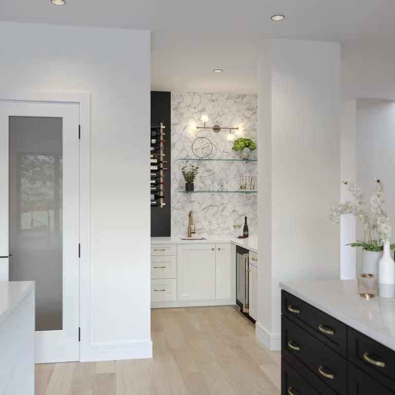 Bright modern kitchen with white cabinets, black drawers, light wood floor, and marble backsplash.