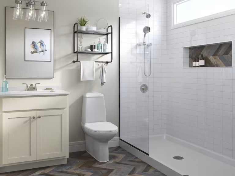 Modern white bathroom with vanity, toilet, glass shower, and tiled walls