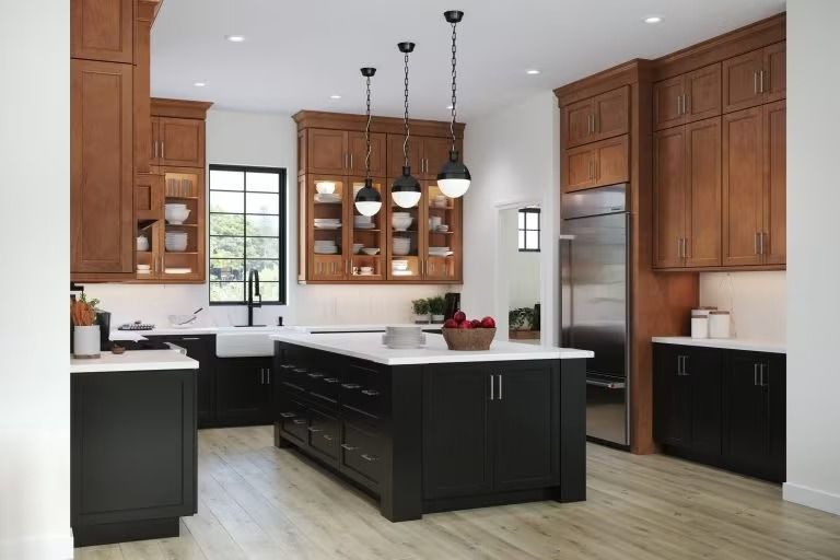 Modern kitchen with dark wood cabinets, white countertops, island, and stainless steel refrigerator