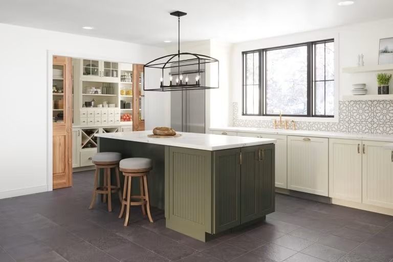 Bright modern kitchen with green island, white cabinets, pendant light, and large window