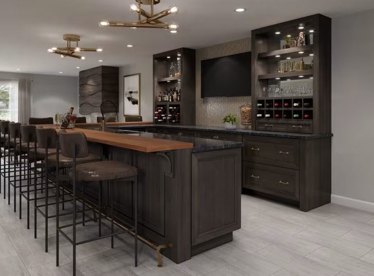 Modern kitchen with a large island, dark wood cabinetry, built-in shelves, and barstools along the counter