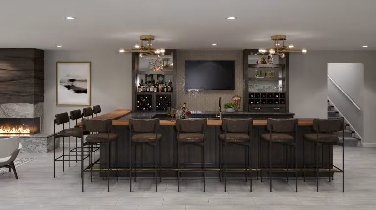 Modern basement bar with black stools, wine racks, fireplace, and wall-mounted TV
