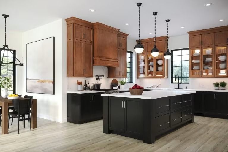 Bright modern kitchen with black island, wood cabinets, pendant lights, and large windows