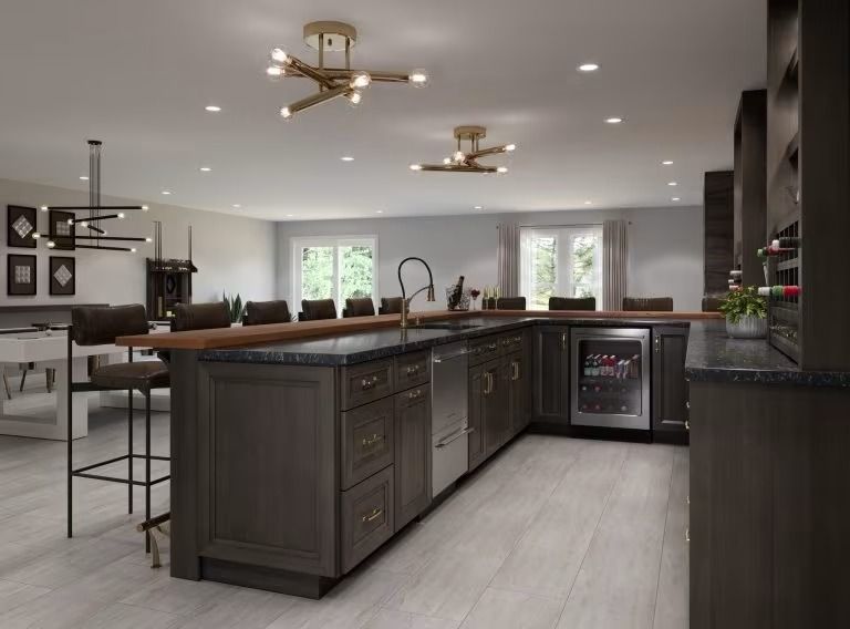Modern kitchen with dark island, stainless appliances, bar stools, and recessed lighting