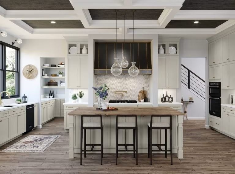 Bright modern kitchen with white cabinets, island, bar stools, and pendant lights