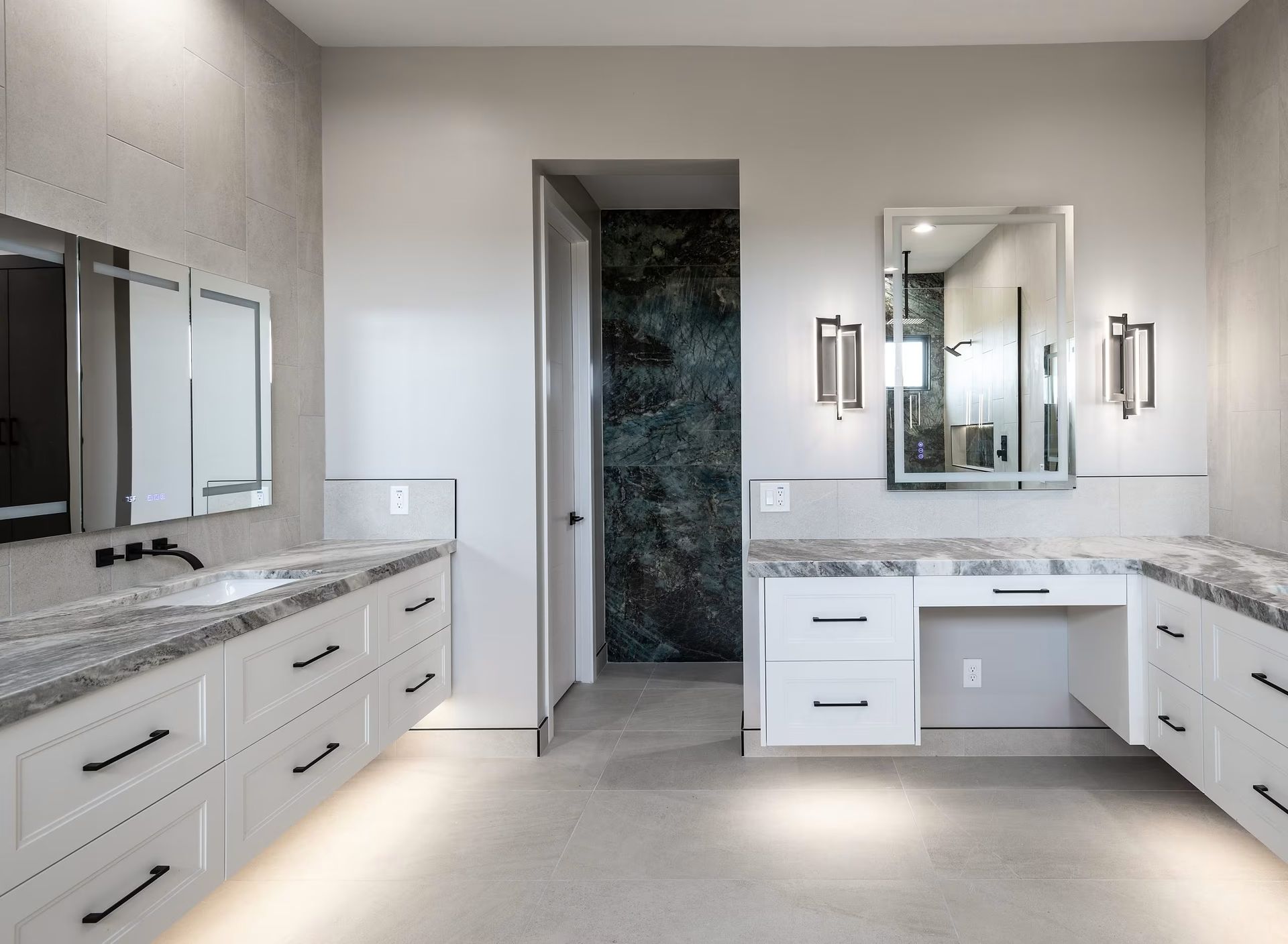 Bright modern bathroom with double vanity, mirrors, white cabinets, and marble countertops